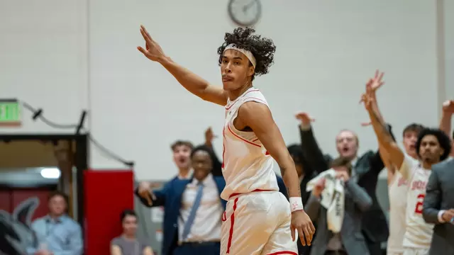 Michael McNair raises his arm in the air after hitting a 3-pointer