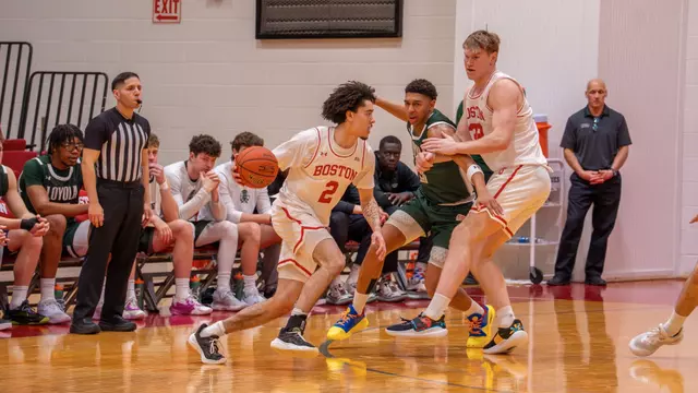 Chance Gladden dribbles the ball toward the hoop with Quinn Nielsen helping set a screen