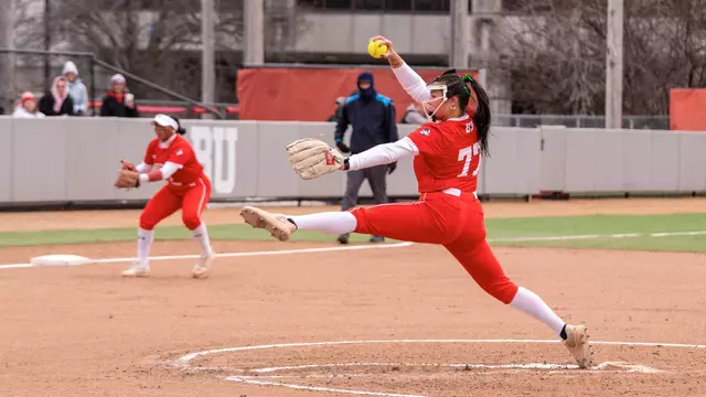 Kasey Ricard is about to finish her pitching motion with arm stretched out looking toward home plate