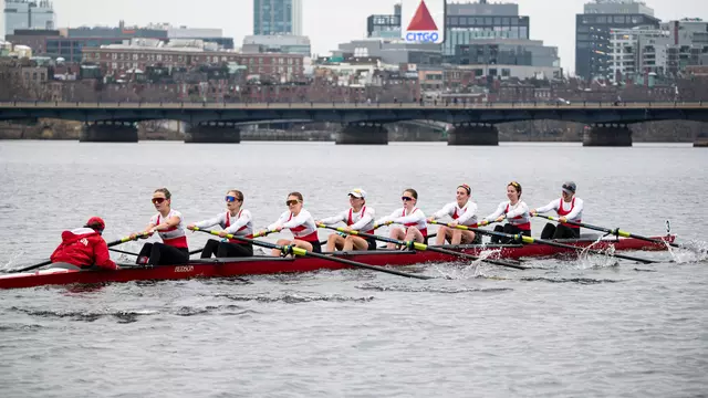 Photo of the BU Lightweight Rowing Varsity 8 racing on the Charles River.