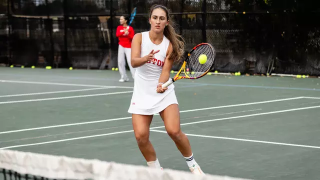 Gabriella Mikaul hits a volley at the net