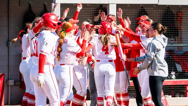 Brooke Deppiesse runs through tunnel created by teammates into the dugout after hitting a home run
