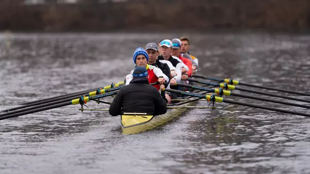 Photo of the BU Men's Rowing Second Varsity 8 practicing on the Charles River.