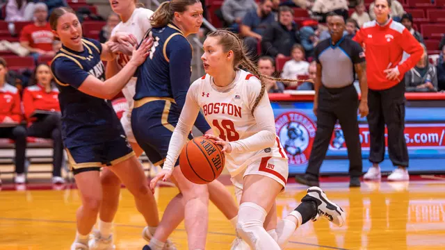 Photo of BU women's basketball sophomore Hildur Gunnsteinsdóttir dribbling against Navy.
