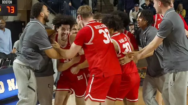 Team celebrates around Chance Gladden after game-winning shot at Navy in Patriot League semifinal