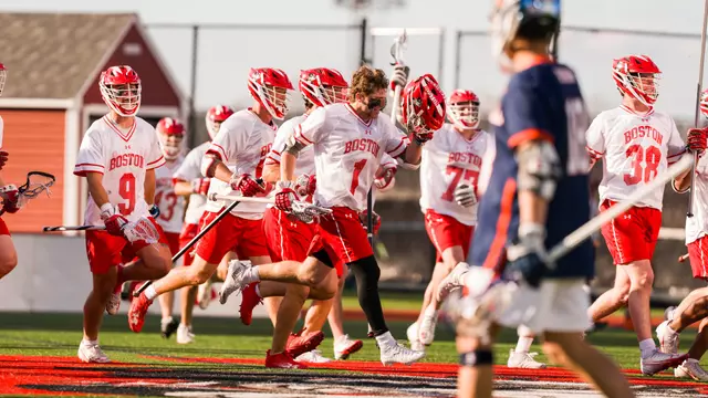 Timothy Shannehan celebrates with his teammates as they run to the fans after an overtime win over Bucknell