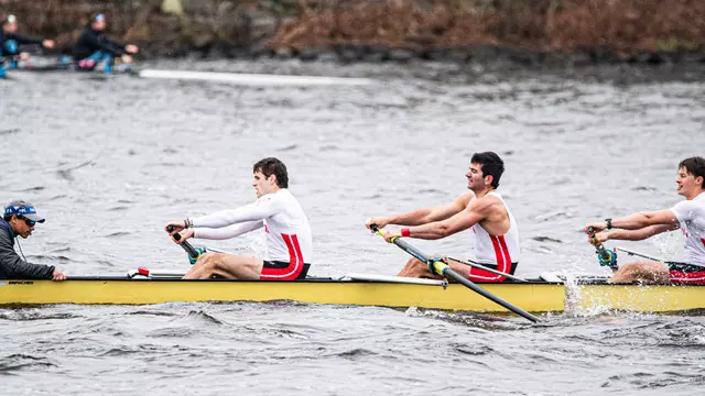 Photo of the BU Men's Rowing Fifth Varsity 8 racing on the Charles River.