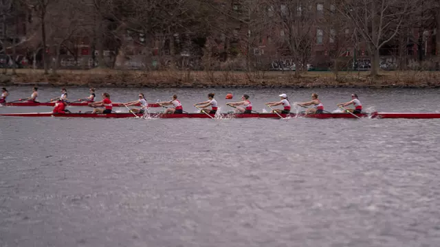 Photo of the BU Lightweight Rowing Varsity 8 racing MIT on the Charles River.