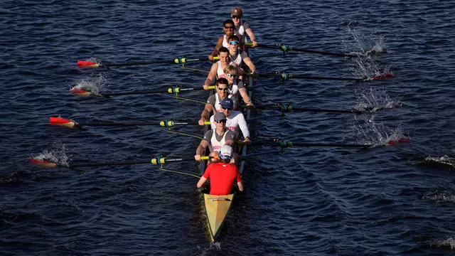 Photo of the BU Men's Rowing Third Varsity 8 racing on the Charles River.