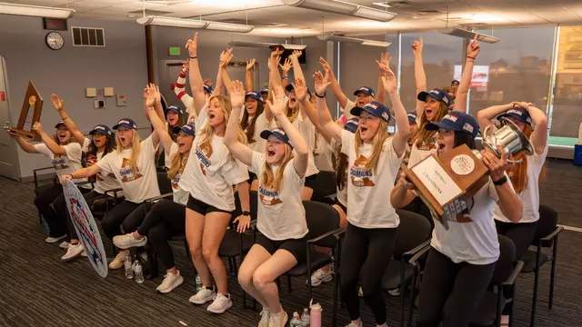 Boston University softball team jumps up in celebration after hearing their name called during the NCAA selection show on ESPN2