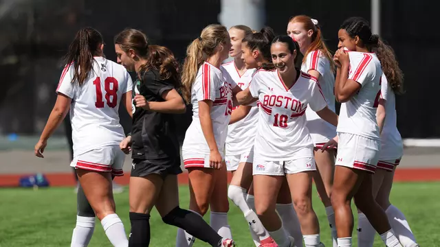 Photo of the BU Women's Soccer team celebrating a goal at a spring match against the Boston Dream.