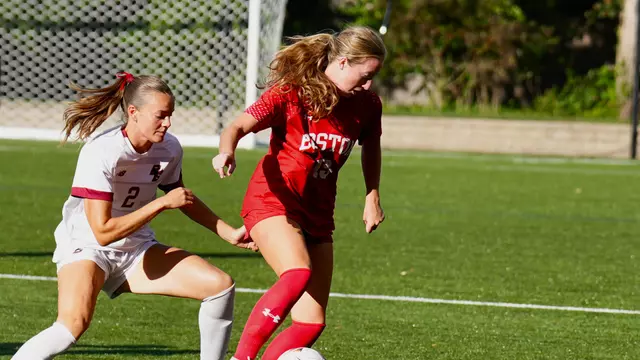 Photo of BU women's socce senior Ava Maguire working against a Boston College defender.