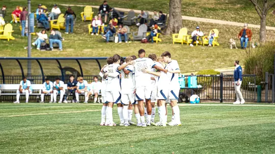 Men's Soccer huddles at the GW Soccer Field