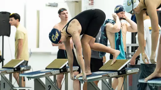 Women's swimming & diving on the blocks at Smith