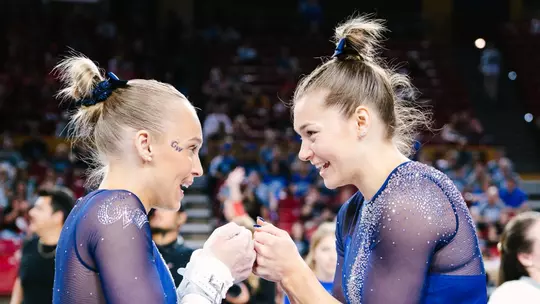 Lola Montevago and Deana Sheremeta fist bump at NCAA Regionals