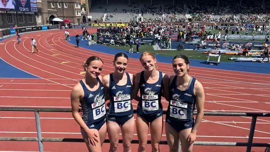 Women's DMR team poses at Penn Relays