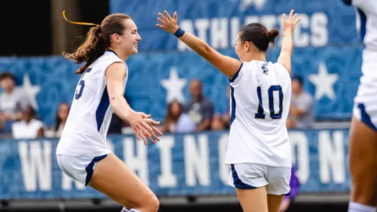 Julia Bilal and Kalia Kau Celebrate a Goal vs. American