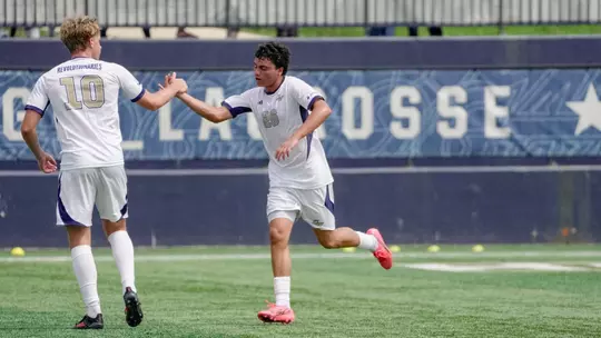 Miguel Sosa high fiving Finn Roberts at the GW Soccer Field
