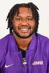Mychal McMullin posed for headshot in purple quarter zip.