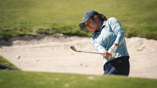 Leon Takagi hits a bunker shot during competition.