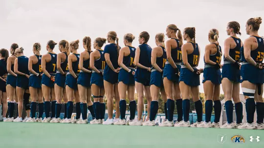 The field hockey team lining up for the national anthem pregame against Penn State
