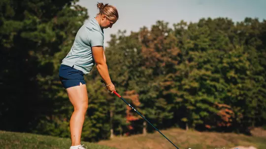Gracie Larsen getting ready to drive a ball of the tee