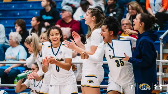 Bench celebrates during game against Walsh