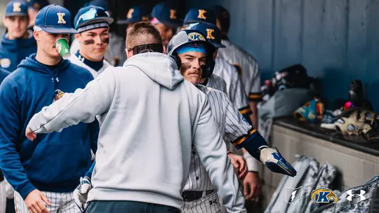 Luke Matthews celebrating in the dugout
