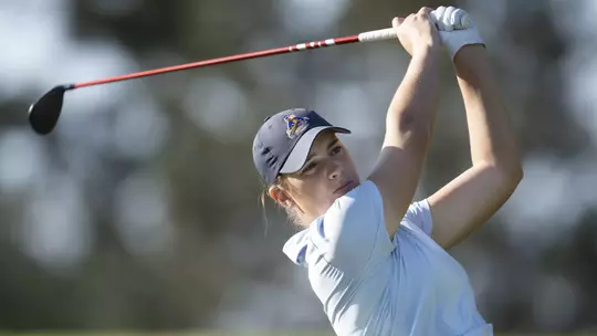 Kent State junior Veronika Kedronová at the top of her backswing with a driver during the first round of the Augusta National Women's Amateur at Champions Retreat Golf Club, wearing a light blue Kent State polo and navy cap with the Golden Flashes logo.