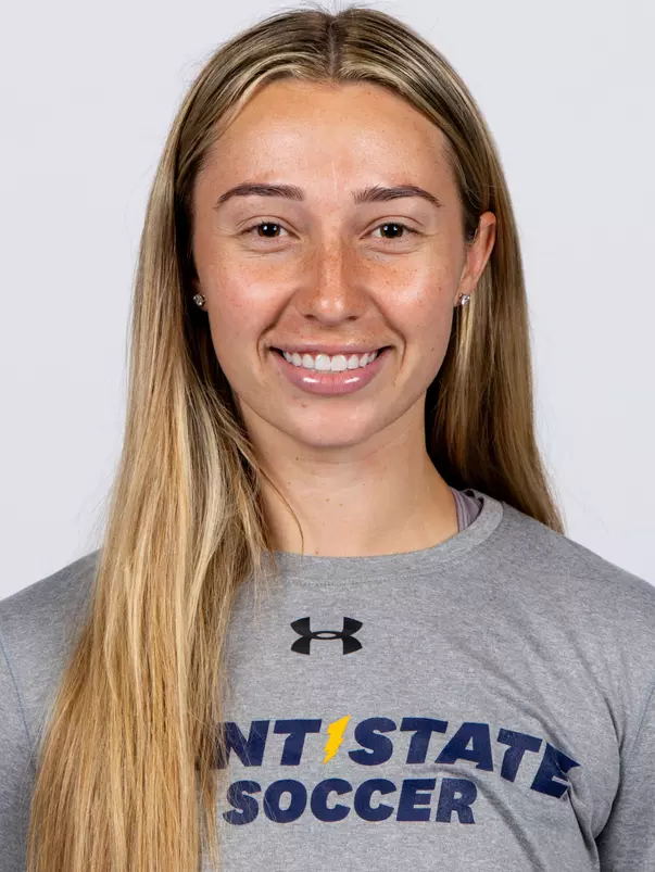 Headshot of Heidi Marshall smiling, wearing a gray Kent State Soccer Under Armour t-shirt, with long blonde hair and small stud earrings.