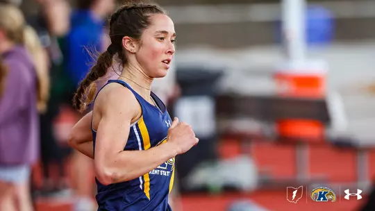 Grace Smith runs the 3,000-meter steeplechase while wearing a navy Kent State track and field uniform.