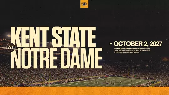 Schedule announcement graphic featuring 'Kent State at Notre Dame – October 2, 2027' in large cream bold text over a dark aerial photo of Notre Dame Stadium packed with fans, with the Kent State Golden Flashes logo at the top center, a brief description of the matchup at right, and a gold bar along the bottom.