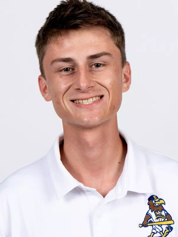 Studio headshot of a smiling young man with short brown hair, wearing a white collared Kent State baseball polo shirt against a plain white background.