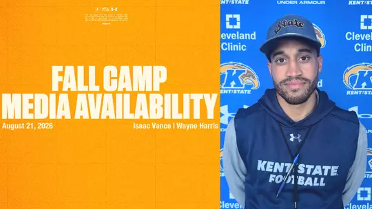 A split-screen graphic for Kent State Football's Media Availability on August 21, 2026. The left side features a gold background listing Isaac Vance and Wayne Harris. The right side shows a photo of a coach wearing a navy "State" cap and a navy "Kent State Football" hoodie against a blue branded backdrop.