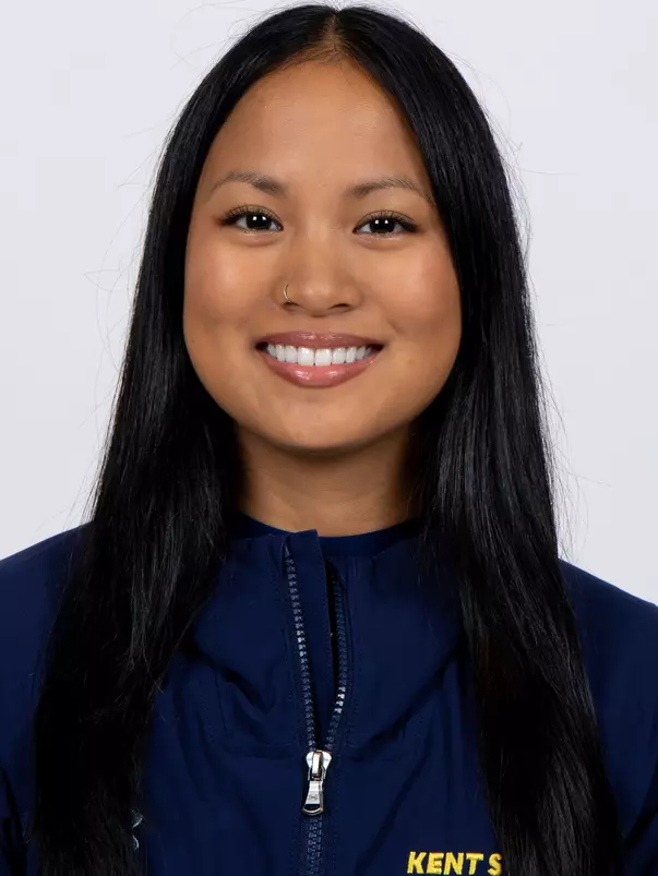 head shot of a Kent State gymnastics student-athlete smiling wearing a navy blue jacket on a white backdrop