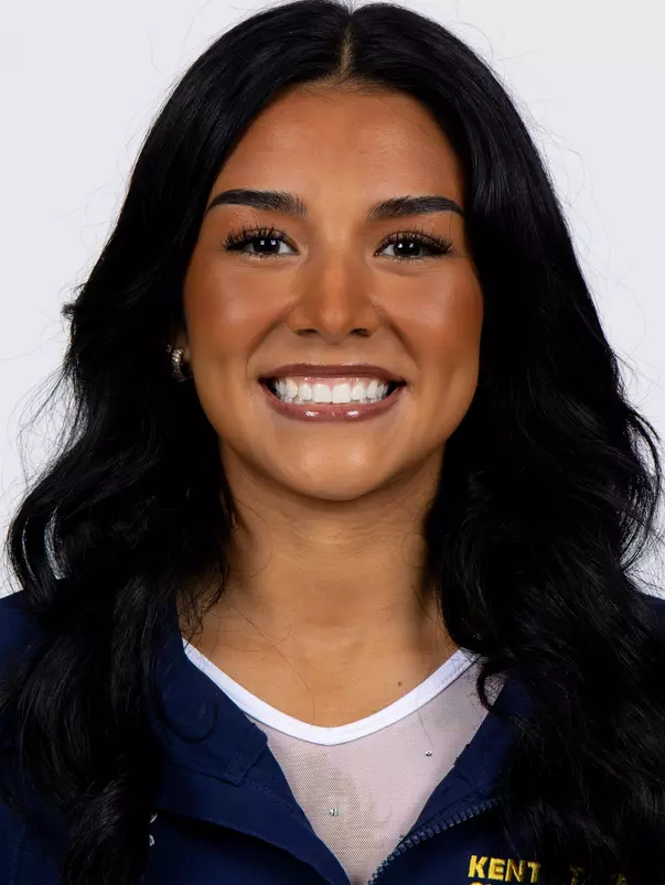 head shot of a Kent State gymnastics student-athlete smiling wearing a navy blue jacket on a white backdrop