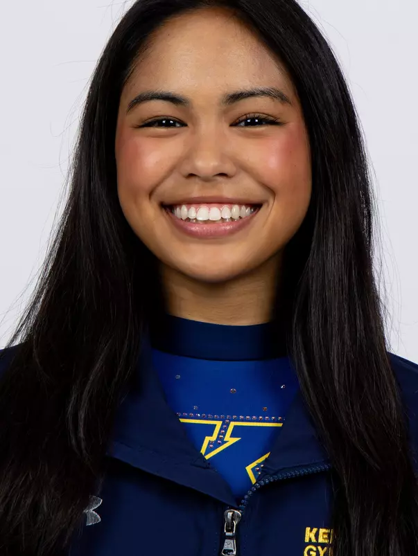 head shot of a Kent State gymnastics student-athlete smiling wearing a navy blue jacket on a white backdrop