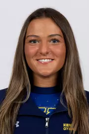 head shot of a Kent State gymnastics student-athlete smiling wearing a navy blue jacket on a white backdrop