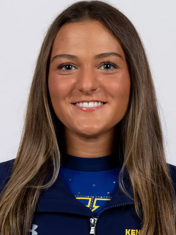 head shot of a Kent State gymnastics student-athlete smiling wearing a navy blue jacket on a white backdrop