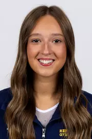 head shot of a Kent State gymnastics student-athlete smiling wearing a navy blue jacket on a white backdrop