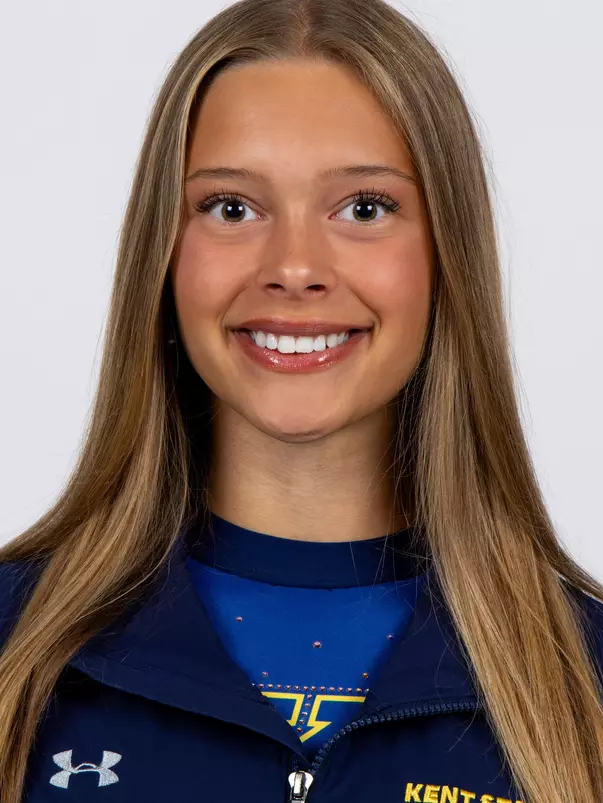 head shot of a Kent State gymnastics student-athlete smiling wearing a navy blue jacket on a white backdrop