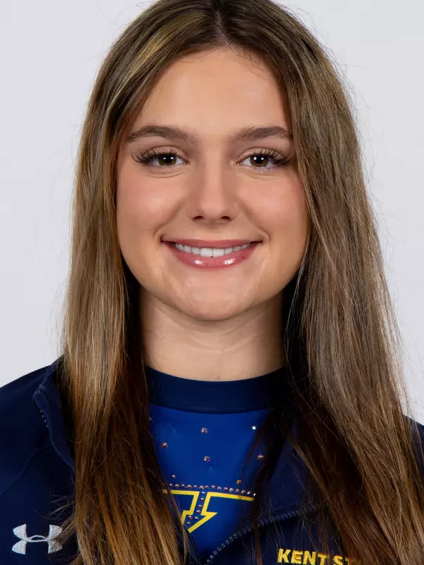 head shot of a Kent State gymnastics student-athlete smiling wearing a navy blue jacket on a white backdrop