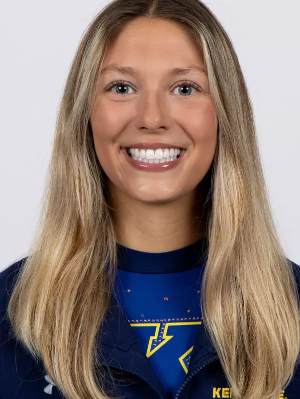head shot of a Kent State gymnastics student-athlete smiling wearing a navy blue jacket on a white backdrop