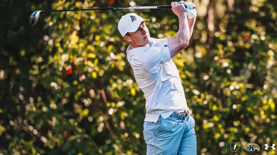 Darcy Hogg chipping with an iron