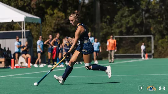 Torie Del Collo striding down the field into UMass' territory with the ball in her possession