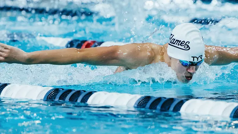 Men’s swimmers push each other to new program records, national cuts at home meet