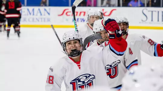 DII women's hockey celebrates goal vs. Huskies