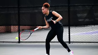 Leena Hamdan hitting a tennis ball with a racquet