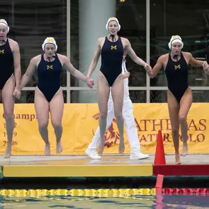 Water polo team jumping into pool