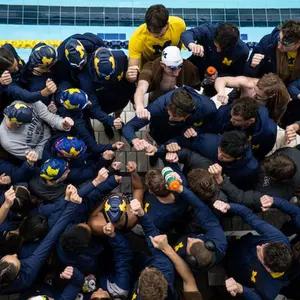 Men's and Women's Swimming and Diving Teams Huddle